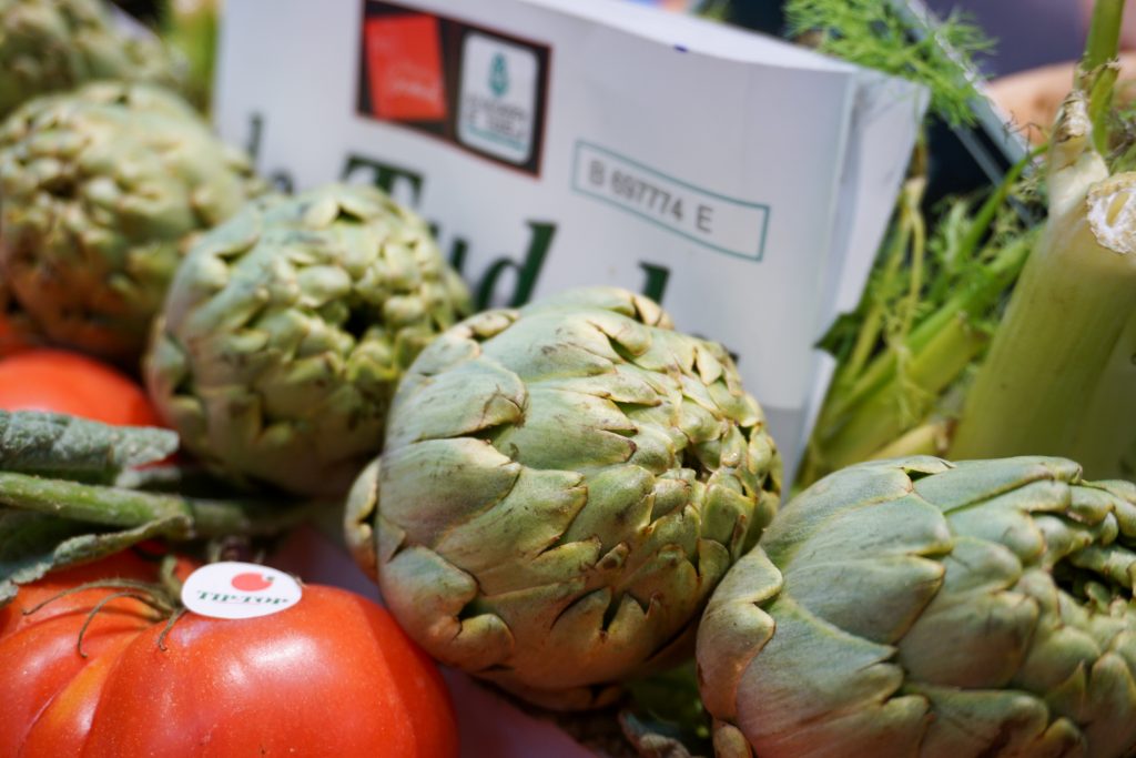 Deliciosas Alcachofas frescas de Tudela expuestas en una frutería del mercado de Santa María de la Cabeza en Madrid
